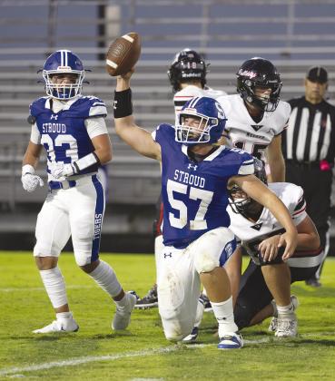 Stroud’s Kaleb Aylor holds the ball aloft after recovering a fumble. Beside him is Gage Bailey (33). Photo/Beth Young