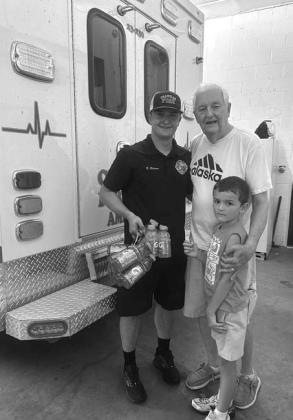 Danny and Archer Alsip deliver a donation of Gatorade to Blake Rickner at the Chandler Fire Department. Thetwowerejustsomeoftheresidentswhodropped donations off at the fire department over the weekend. A community call for donations of bottled water, sports drinks and hydration drink mix packets went out onAug. 13 as high temperatures continued across Lincoln County. Photo/Danny Alsip