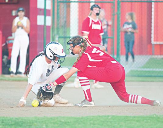 Right, Diana Manning (in red) reaches for a throw at second against Meeker in the regional tournament. Archive photo/Brian Blansett