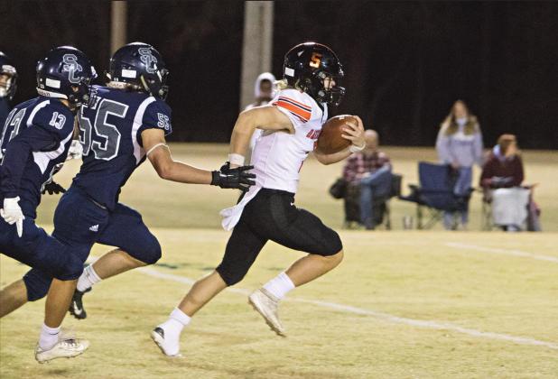 Carson Funk (5) is off and running and towing some Summit Christian defenders in his wake. Photo/Adam Ewing