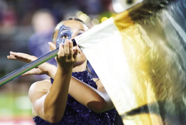 Lizzy Pryor of the Chandler color guard keeps her focus intense during the halftime performance at the Chandler-Prague football game Friday night. Chandler won the game, 45-7, and will host Stroud in their annual rivalry game this week and Prague goes to Meeker for their annual Highway 62 showdown. Both games will kick off at 7 p.m. Photo/Brian Blansett