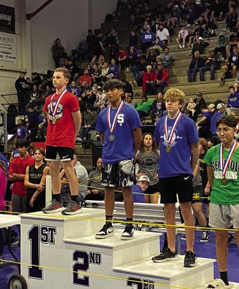 Stroud’s eighth-grade powerlifting team took second at the state meet last week. Pictured above are team members Colten Harrison, Devin Murfin, Zane Charkowski and Aiden young. Above right is Colten Harrison, who is on the medal stand for winning first place in 157-lb weight class with a 950-lb total. Devin Murfin took 2nd place in 105-lb weight class with a 605 total. Bottom right is Devin Murfin on the medal stand in second place.