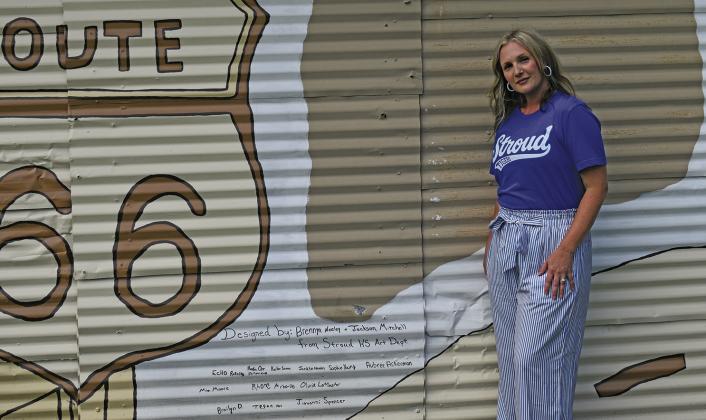Art teacher Leslie Martin stands next to the signatures of students who helped create a mural east of Stroud on Route 66. Photo/Emily Kalka