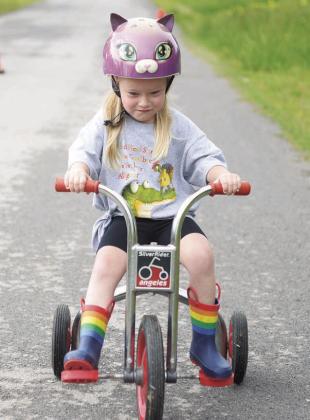 Stroud Head-start held its annual Trike-a-thon for St. Jude last Friday. The class raised $450 in donations for St. Jude Children’s Research Hospital. Pictured below is Lydia Biswell having a great time even with a slightly sideways helmet. To the right is Charlee Billings, focused on the finish line. Photos/Baylee Blancarte