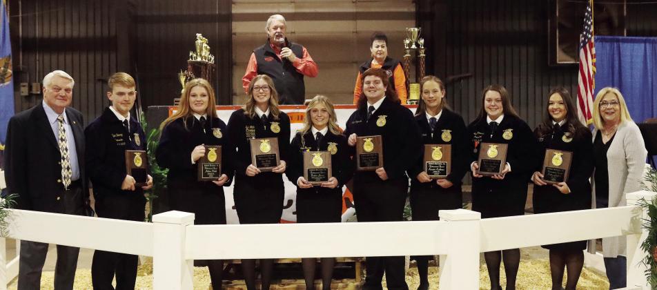 This year’s recipients of the Gordon Richards, Sr. Achievement Award sponsored by the Clinic Pharmacy shown at the Pott County livestock show premium show. Area recipients are Madison Bickel, McLoud, third from left; Berklee Gossen, North Rock Creek, fifth from left; and Morley Griffith, Dale, second from the right. Also shown are Gordon Richards, Jr., left, who helps sponsor the award and Jamie Barrick, right, of The Clinic Pharmacy. In the rear are Randy and Suzanne Gilbert. Photo/Amy Hasbell
