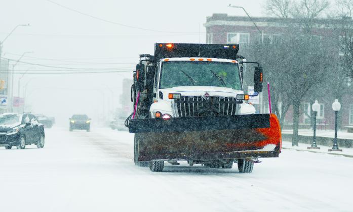 Downtown Chandler looked like Minnesota for a while on Sunday as snow flakes fell and gravel trucks and blades moved through. See the article on Page 2A. Photo/Brian Blansett