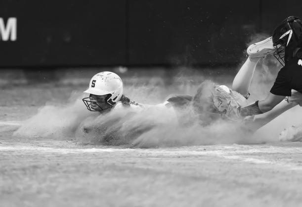 Above, the Prague defense swarms a Keifer ballcarrier. Photo/Rick Hester Right, Miyah Clark slides home in a cloud of dust in the state tournament against Latta. Photo/ Rick Hester Left, Chandler’s London Ward steams for yardage against Tulsa Webster. Photo/Brian Blansett