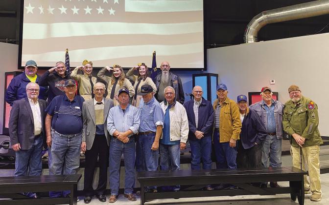 The Stroud American Legion Auxiliary and Town Talk hosted the Andrew Sisters tribute triolast week as a thank you to veterans. Pictured above are the trio and veterans who attended. Photo/provided