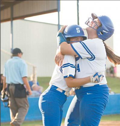 Above, Kenlee Parrick gets a hug from Stroud teammate Emma Davis after scoring in the ninth inning Friday. Top left, Chandler catcher Grace Haas throws to first after fielding a bunt while Stroud coach Lezli Robinson, background, holds a runner at second. Left, Davis takes a throw to force Cashia Herber at the plate in the seventh inning. Photos/Brian Blansett