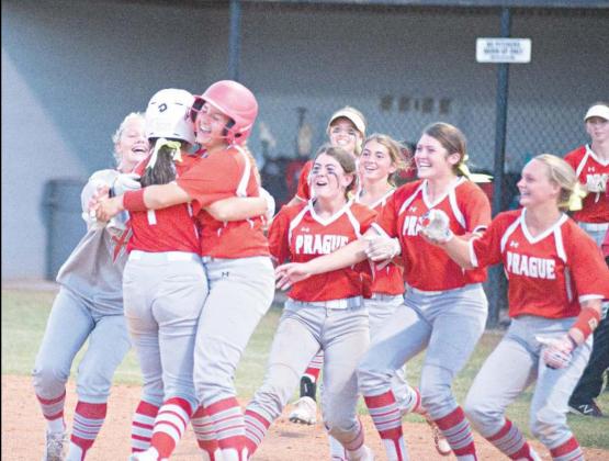 Lexsey Trevizo is mobbed by her Prague teammates after her game-winning hit Monday against Meeker. Photo/Brian Blansett