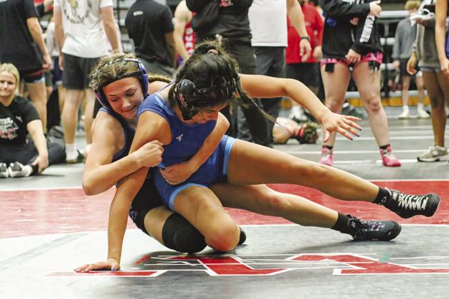Lizzy Pryor, with blue headgear, on her ay to taking second place over the week at the Mark Peck Tournament. Photo/Jennifer Pryor