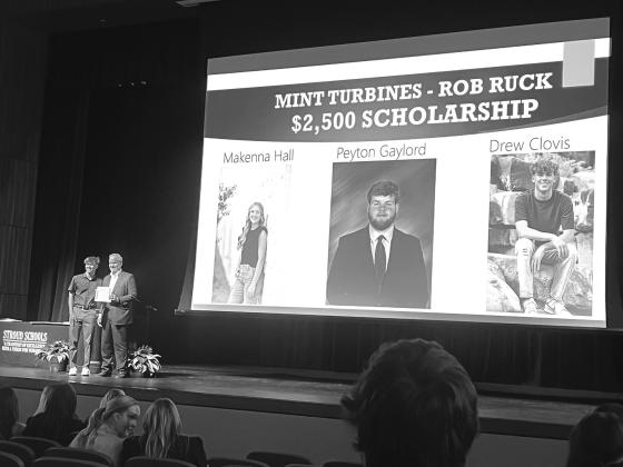 Robert Ruck, president and COO of M International, presents Drew Clovis from Stroud with a $2,500 scholarship from Mint Turbines and M International at the Stroud Awards Ceremony in May. Peyton Gaylord from Davenport and Makenna Hall from Stroud also recieved scholarships. Photo/Mint Turbines