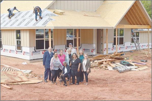 The Chosen House Board of Directors stands before the new location currently under construction. They are Ginny Fowble, chairman of the board; Ashlea Guthrie, secretary; Bonnie Walkingstick; Debbie Collins; Lorenzo Jacobs; Lettie Green; and Larry Freeman. Not pictured is John Collins, treasurer. Photo/Emily Kalka