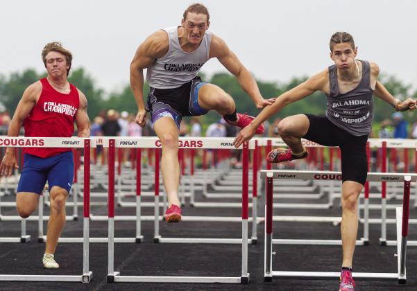 North Rock Creek’s Maddox Motley (center) and Chandler’s J. Hunter Duncan (right) clear the final hurdle in the 110-meter event at the Meet of Champions last week at North Rock Creek. Motley, the state champion in Class 4A, edged Duncan, the state champion in Class 3A, by 5/100ths of a second, 14.76 seconds to 14.81. For more photos from the meet, please see Page 2A. Photo/Mario Holland
