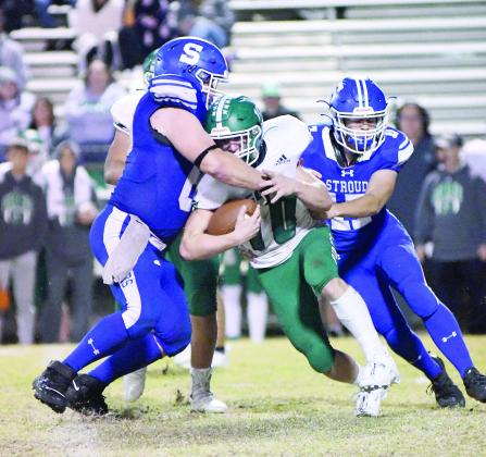Stroud’s Peyton Gaylord, left, and Taylor Rozell, right, make a tackle in the Tigers’ playoff win over Gore. Photo/Brian Blansett