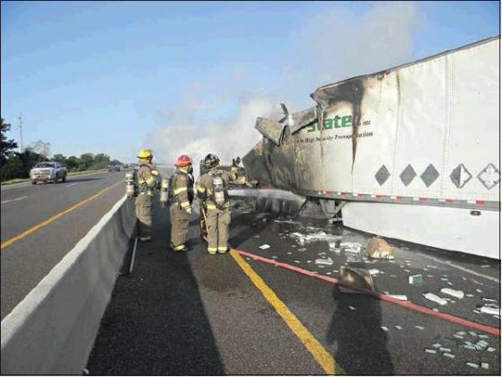 Firefighters hose down a semi that crashed on the Turner Turnpike. Photo/Jessica Pollard