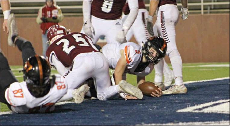 Quarterback Carson Funk (5) checks to make sure the ball is across the goal line during Davenport’s state semifinal game against Shattuck. Photo/Kim Hobill