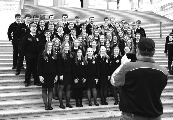 Kaydence Staude and Baylee Weeks stand with other participants at a leadership conference. Photo/Meeker FFA