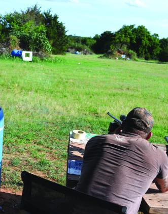 Hunting guide Chris Cole sets up the sight on a rifle at the target range at 405 Outfitters. Photo/Emily Kalka