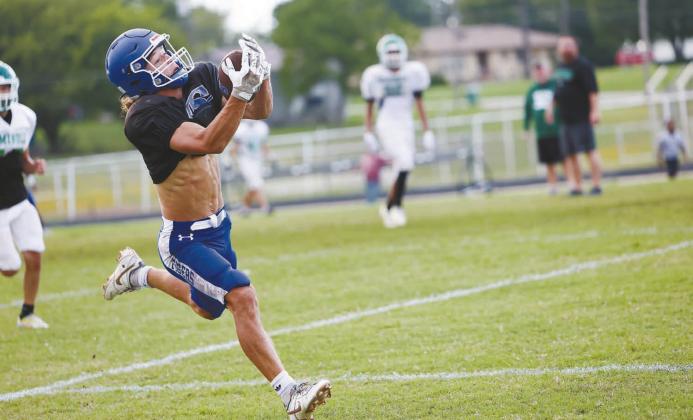 Right, Chandler’s offense operates from deep in its own territory in last week’s scrimmage against Meeker. Photo/Brian Blansett Below, Stroud’s Aiden Collins had the secondary largely to himself for this touchdown catch in the Tigers’ scrimmage with Seminole. Photo/Beth Young