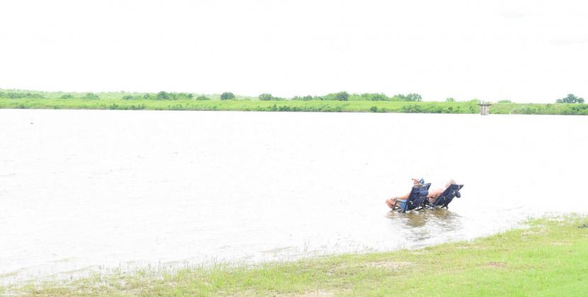 Logan Trout of Tulsa &amp;amp; Natalie Moore of Stroud relax on an area typically above water at Stroud Lake, Friday, July 2. Photo/Kendra Johnson