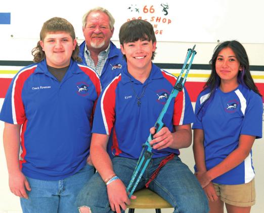Chandler archers going to nationals, from left, defending world champion Caden Eyestone, coach Ty Rhoades, Kyzer Guthrie and Lexi Martzall. Photo/Brian Blansett