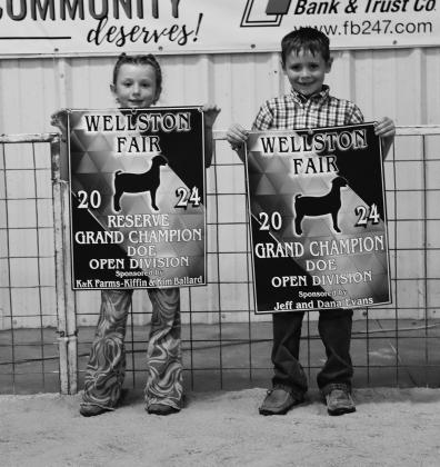 Goats: Chesney Bailey (left) and Ridge Priddy (right) pose with their banners after the Pee Wee Goat Show at the Wellston Fair Livestock Show. Bailey won second place and Reserve Grand Pee Wee Doe. Priddy won first place and Grand Pee Wee Doe. Photo/Caylyn Cunningham