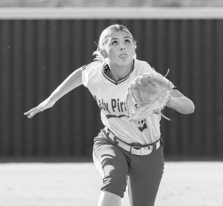 Carney pitcher Italy Ventris is all focus as she pitches in the Lady Bulldogs’ game against Wellston laast week. Photo/Brian Blansett. Below, Dale’s Breeze Higdon hustles in from left field to make a diving catch in foul territory. Photo/Rick Hester.