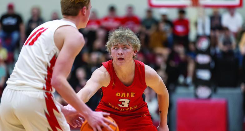 Above, the Prague Red Devils celebrated Saturday after beating Holdenville, 57-49, in the regional tournament and keeping alive their season and hopes of returning to The Big House. Below, Denton Forsythe lines up another steal forthe top-ranked Dale Pirates. Photos/Rick Hester.