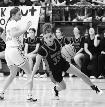 Above, Remington Martin (24) from Carney attacks the lane for a shot during the Bulldogs’ game at Wellston Tuesday night. Defending for Wellston is Wylee Terrell (3). Top right, Mason McCarty (24) from Wellston gets a rebound against Carney’s Isaiah Schmidkunz (3). Above right, Wellston’s Brookelyn Terrell (33) drives against Alexa Ward (23) from Carney. Photos/Brian Blansett