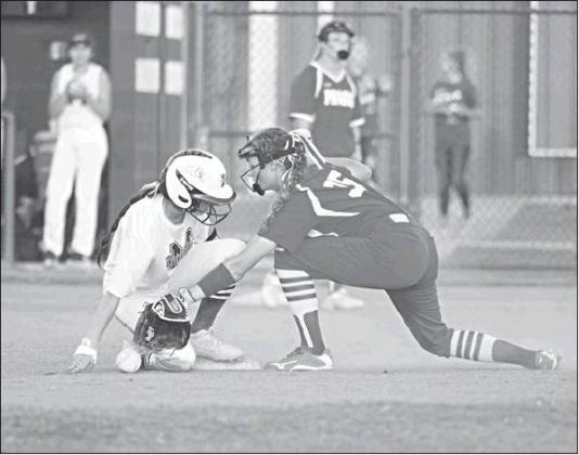 Prague second baseman Diana Manning reaches for the ball as Meeker’s Madison Buoy comes in safely in their game Thursday. Photo/Brian Blansett