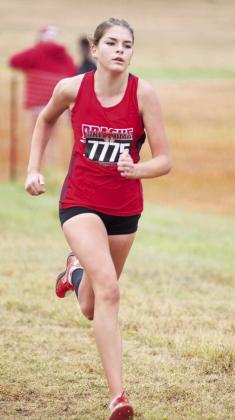 Above, Hailey Johnson nears the finish line en route to a sixth-place finish at the state cross country meet on Saturday. Below, Madelyn Bridge motors through a straight-away and, right, Cooper Emmons from Davenport kicks toward the finish line. Photo/Brian Blansett