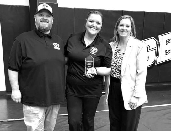 Chamber President Erin Bradley (right) presents the Business of the Year Award to Five Star BBQ. Photo/ Stroud Chamber of Commerce