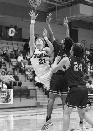 Above, the district champion Dale Pirates and Lady Pirates. Photos/ Rick Hester. Below, Kage Danker puts up a shot in the lane for Wellston during regional play. Photo/Jeremy Self.