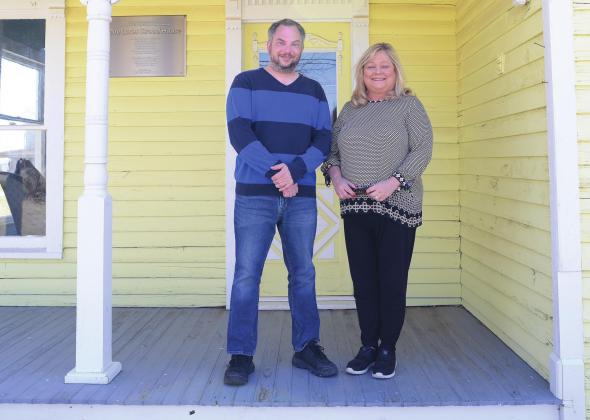 Composer Nolan Stolz and Diana Reed stand on the porch of the Lucas Stroud House last week. Stolz has been touring Route 66, gleaning inspiration for a musical suite he will write about the 100th anniversary of the highway. Photo/Brian Blansett