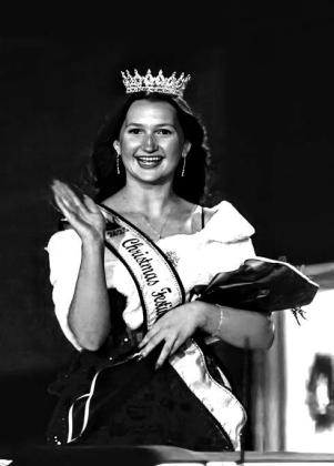 Christmas Festival Queen Mattie White waves at the crowd as she makes her way down the parade route. Photo/Jennifer Pryor