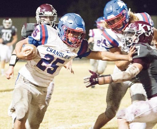 Casmen Hill (25) shoves a would-be tackler out of his way while racking up some of his 341 rushing yards against Kellyville. Photo/Chelsea Weeks