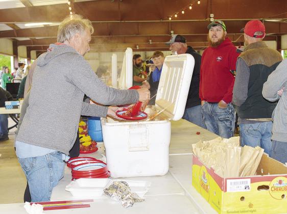 A portion of an estimated crowd of 400 go through the line at the annual Bell Cow Boil Crawfish Festival Friday in Chandler. Sponsored by the Chandler Area Chamber of Commerce, the festival featured traditional Cajun food, music and games. Photos/ Baylee Blancarte