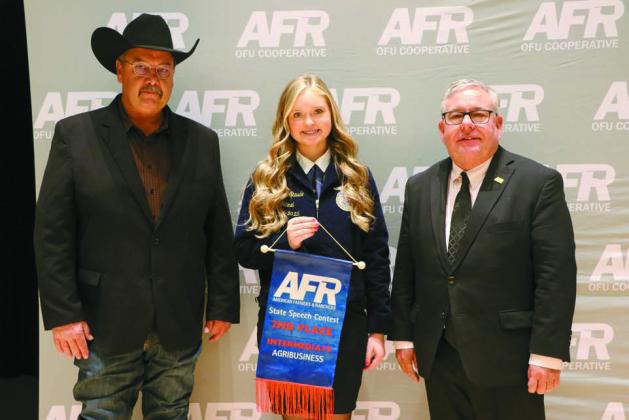 Meeker sophomore Kaydence Staude (center) from Meeker stands with AFR Cooperative Vice President Toby Wallace (left) and AFR Cooperative President Scott Blubaugh (right) after placing second in Intermediate Agribusiness at the AFR State Speech Contest on Dec. 7. Photo/AFR