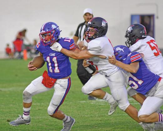 Chandler quarterback Kaden Jones (11) runs for yardage in the first half. Blocking for Chandler is Stran Messer (51). Photo/Brian Blansett