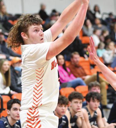 The Summit Christian bench has all eyes on Joey Chrisman as he fires in one of his nine three-pointers for Davenport on Saturday. Chrisman finished with 31 points, almost half of Davenport’s tally, and led the Bulldogs to the district championship. Photo/Brian Blansett