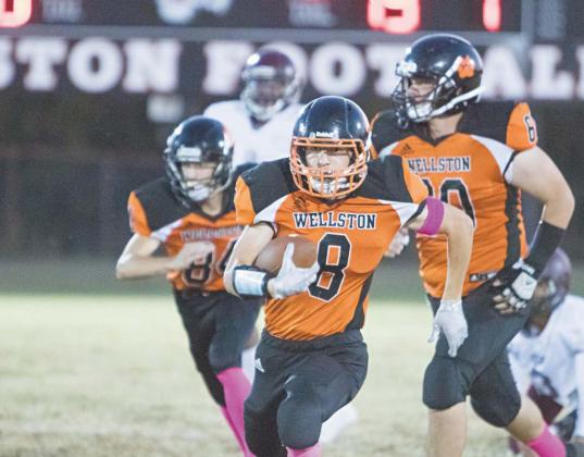 McKoy Coulson (8) hits high gear on a touchdown run Friday night against Sunrise Christian Academy. Accompanying him are blockers Cole Sikes (84) and Cody Cook (60). Photo/Brian Blansett