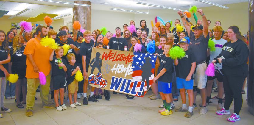 Chandler teen Will Conley is surrounded by friends, family, and his medical teams welcoming him home on July 10 in the lobby of the Bethany Children’s Health Center in Bethany. After over 100 days spent in hospitals, Conley is finally returning to Chandler to continue his physical and occupational therapy. He was injured in the March 14 wildfires, sustaining burns on over 60 percent of his body. Photo/Emily Kalka