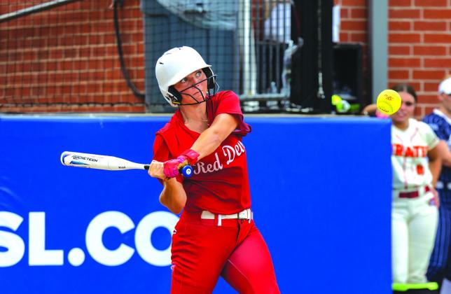 Kacey Cantrell from Prague gets a hit to make it to first base. Photo/Rick Hester