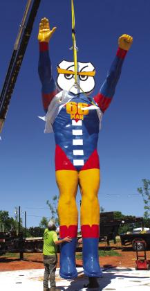 A worker steadys 66 Man as he comes in for a landing at the front of McClanahan Park in Chandler on Monday. The character was created by Jerry McClanahan, whom the park is named after. Photo/Andrew Frazier
