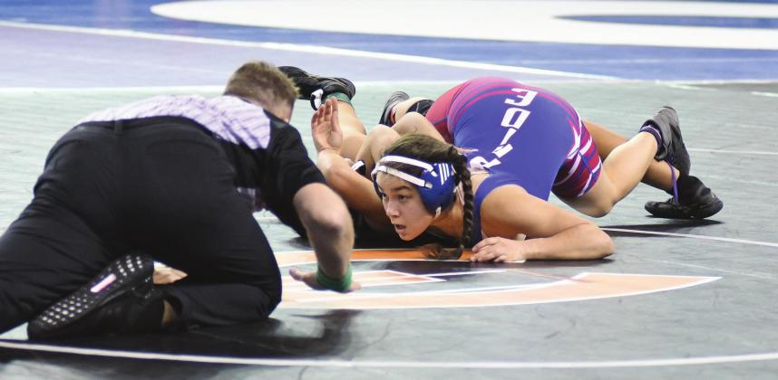Alison Conway watches as the ref slaps the mat to signal she pinned Elizabeth Mullendore during the first round of the first-ever girls wrestling state tournament last week. See Pages 2A and 3A for more state tournament photos. Photo/Brian Blansett