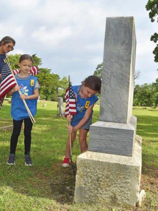Girl Scouts place flags