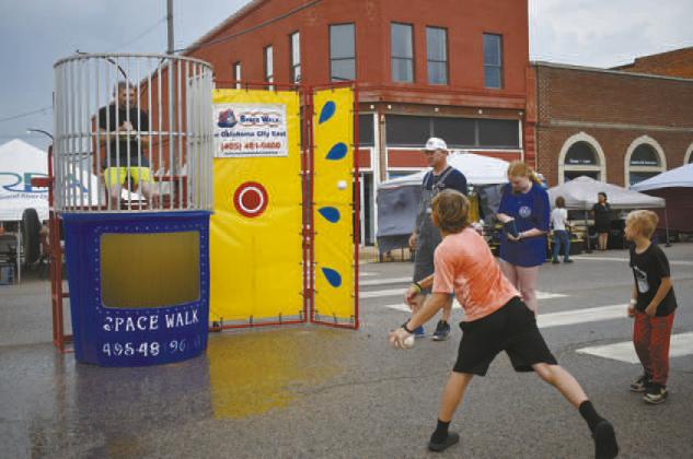 Jason Mooy encourages kids to try and hit the target to dunk him at Stroud Summer Fest.