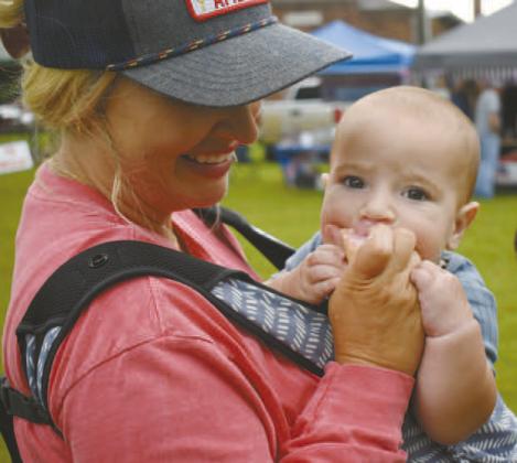 Baxter Schubert enjoys his first ice cream with his mother, Ashley Schubert, at Chandler’s Ice Cream Festival in Tilghman Park on Saturday. Photos/Emily Kalka