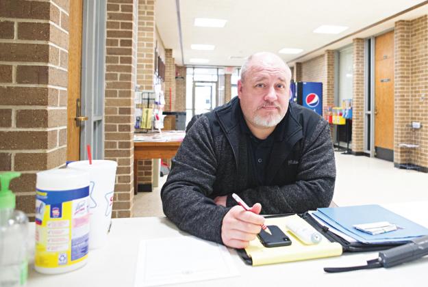 Kevin Chapman of the Lincoln County Sheriff’s Office sits at the metal detector at the front door of the courthouse on Tuesday. People going inside had to fill out a health questionnaire and have their temperature taken, in addition to normal security measures. Photo/Brian Blansett